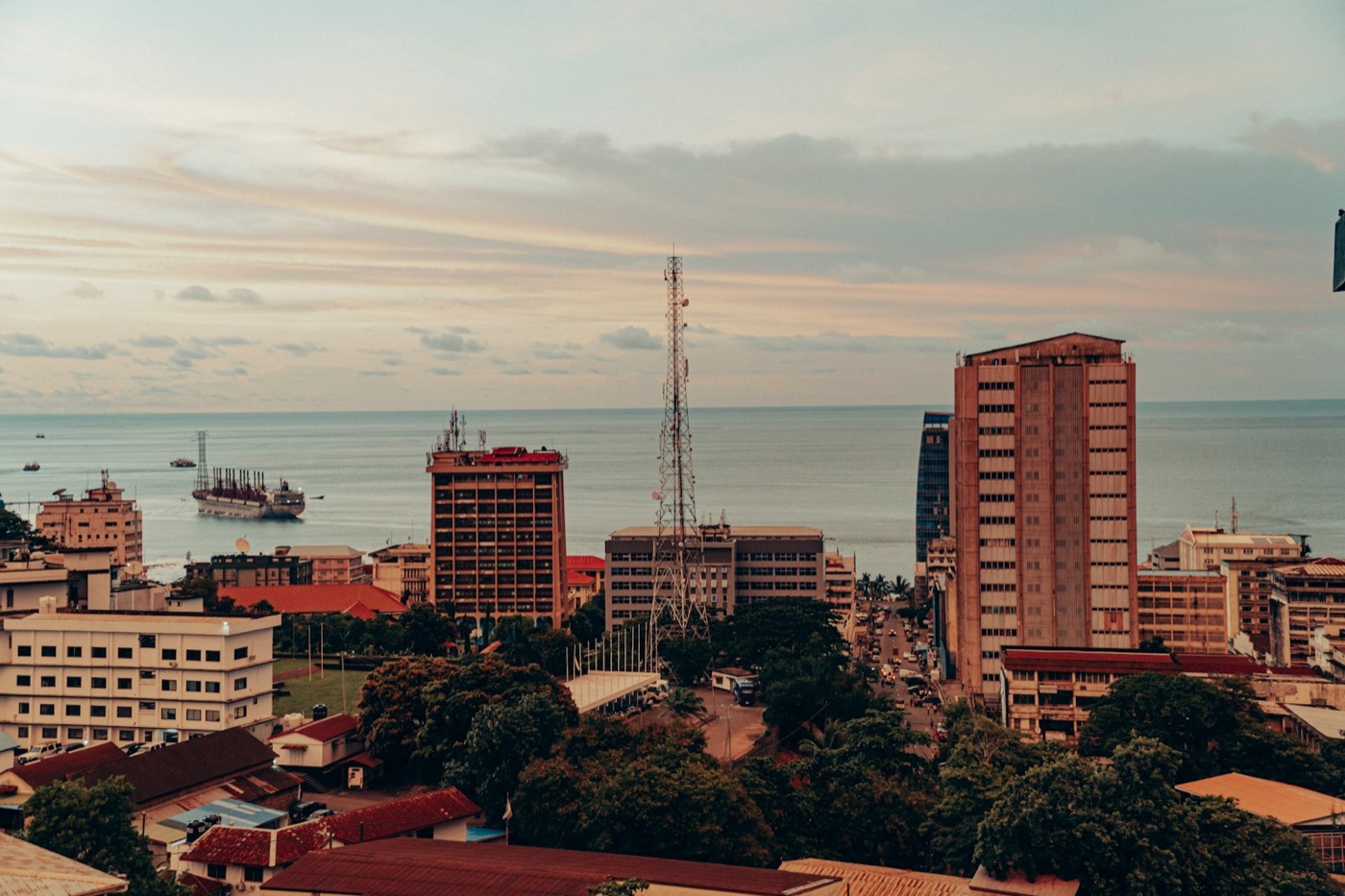 Downtown Freetown at dusk, with ships anchored in the harbour